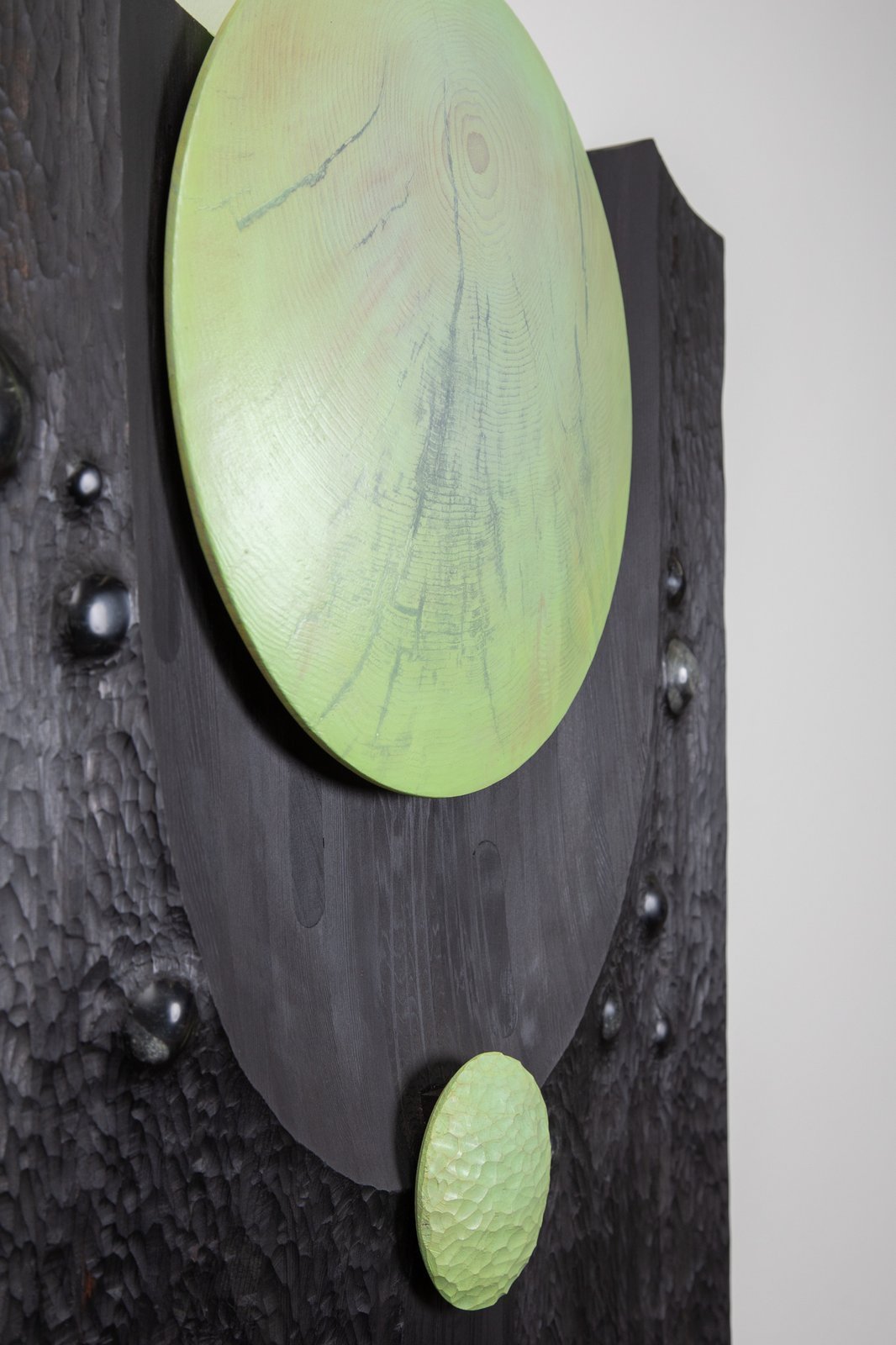 Knowledge of the Spirit, detail — end-grain wood disc and embedded black glass