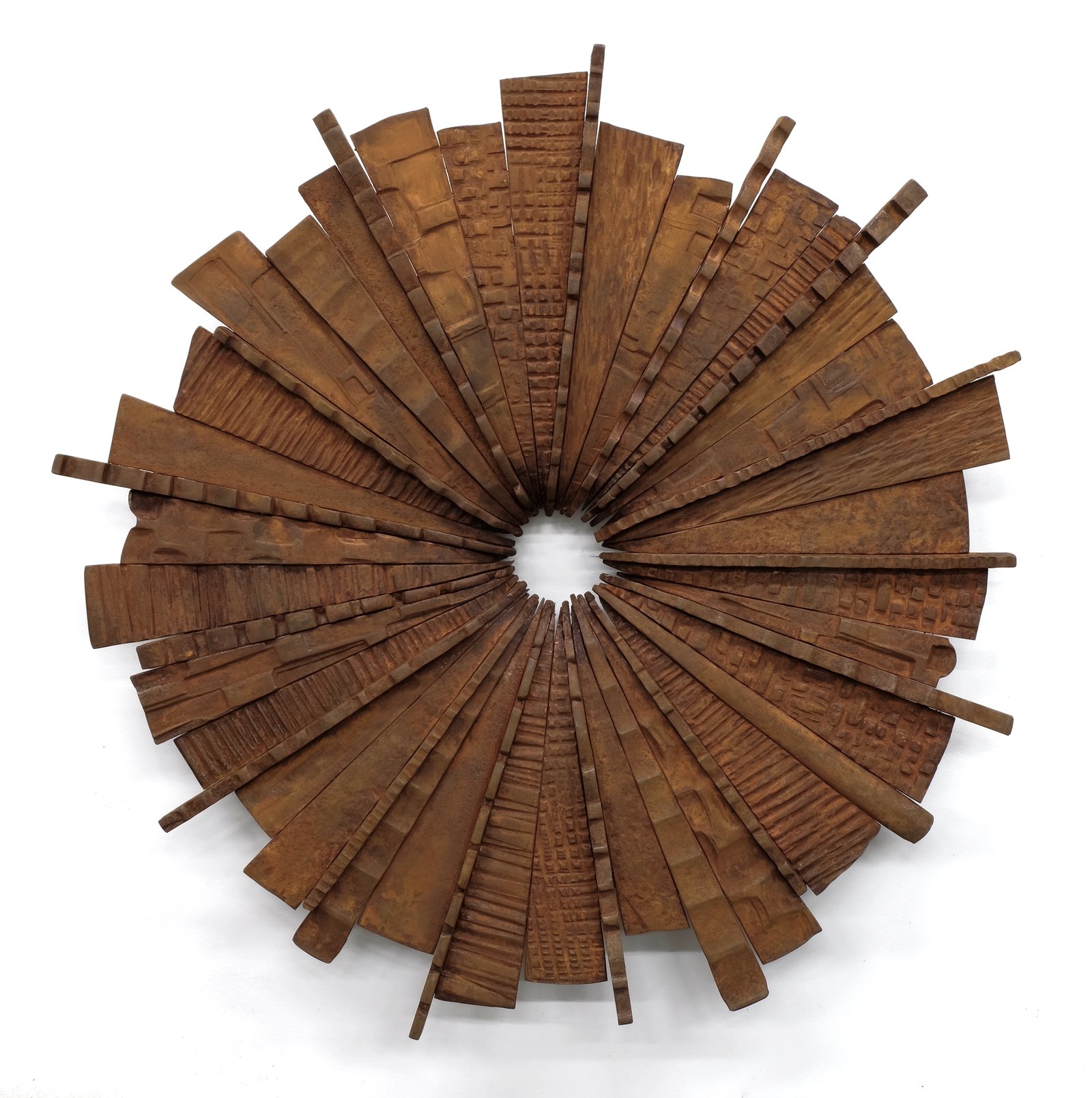 Iron Sun by Maria Cristalli — rusted steel circle with radiating textured pieces